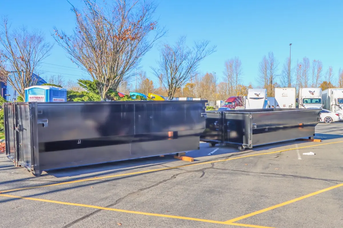 Professional dumpster rental service with roll-off container on residential driveway in Prairie Grove